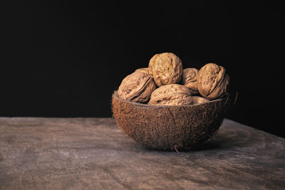 Close-up of fruits on table against black background