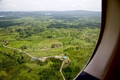 Green landscape seen through airplane window