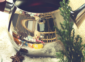 Reflection of toys on tea kettle