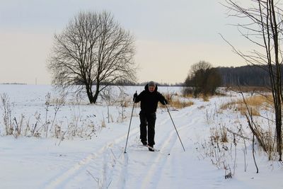 Full length of man on snow field against sky