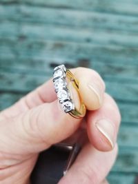 Cropped hand of woman holding diamond ring