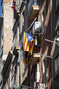 Low angle view of flags hanging on building