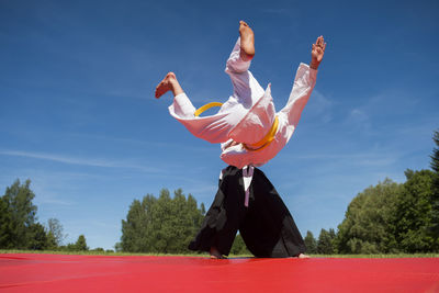 People playing karate against sky
