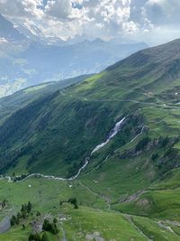 Scenic view of green landscape against sky