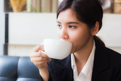 Close-up of businesswoman drinking coffee