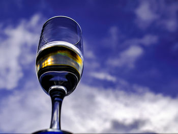 Low angle view of illuminated street light against blue sky