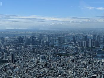 Aerial view of modern buildings in city against sky