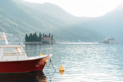 Scenic view of sea and mountains against sky