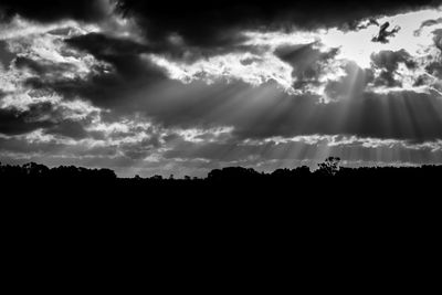Silhouette landscape against dramatic sky