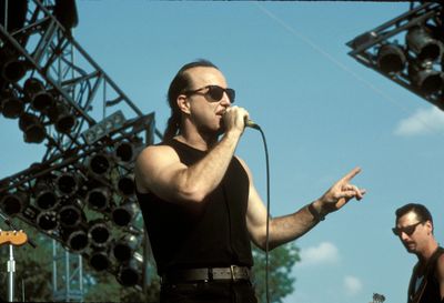 Young man wearing sunglasses standing against sky