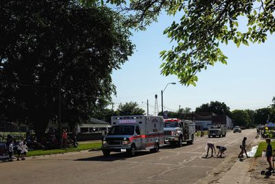 Vehicles on road in city against clear sky