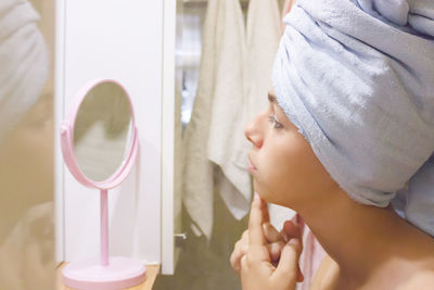 Close-up portrait of a young woman with reflection