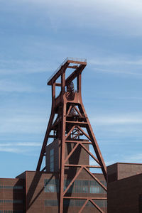 Low angle view of building against cloudy sky