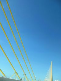 Low angle view of bridge against clear blue sky