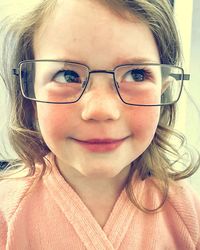 Close-up of girl wearing eyeglasses looking away