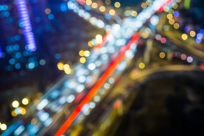 Defocused image of illuminated cityscape at night