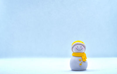 Close-up of yellow toy against blue background