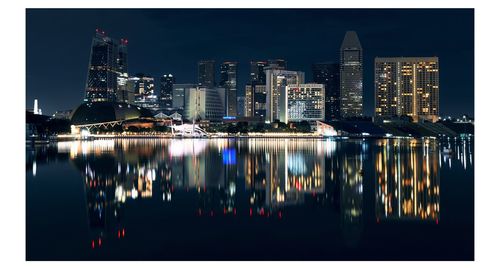 Reflection of illuminated buildings in water at night