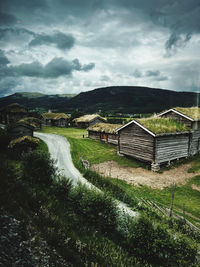 Houses on field against sky