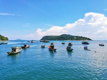 Boats moored on sea against sky