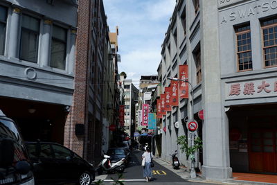 Vehicles on road along buildings