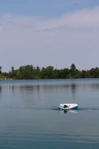 Woman swimming on inflatable ring in lake