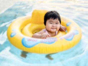 Portrait of cute girl swimming in pool