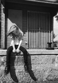 Full length of boy on floor against building