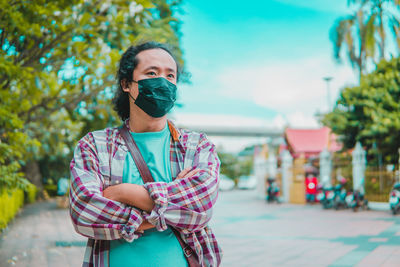 Young woman wearing mask while standing outdoors