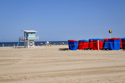 Lifeguard hut on beach against sky