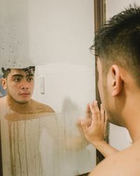 Young man looking at mirror