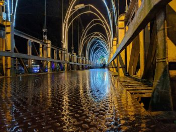 Illuminated bridge in city at night