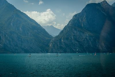 Scenic view of sea and mountains against sky