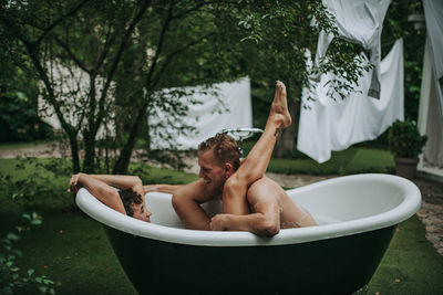 Couple in bathtub outdoors