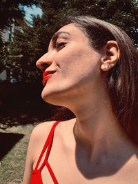 Close-up portrait of a young woman looking away