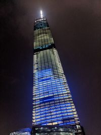 Low angle view of illuminated building against sky at night