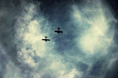 Low angle view of airplane flying in sky