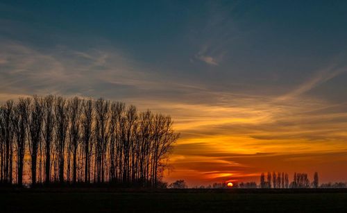 Scenic view of landscape against sky at sunset