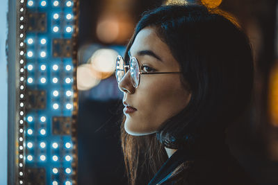 Close-up portrait of young woman looking away