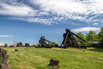 Traditional windmill on field against sky