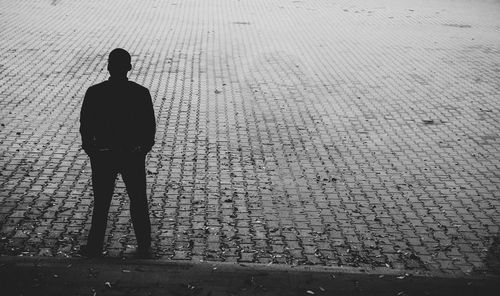 Silhouette man standing on street