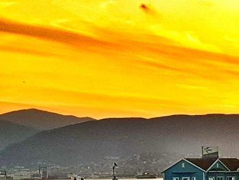 Scenic view of mountains against sky at sunset