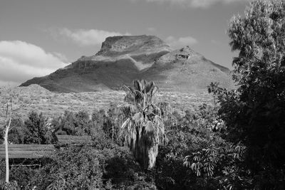 Scenic view of mountains against cloudy sky