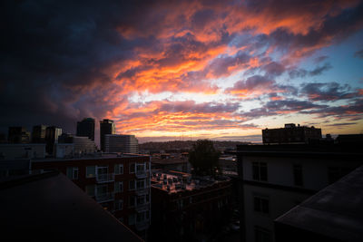 View of cityscape against cloudy sky during sunset