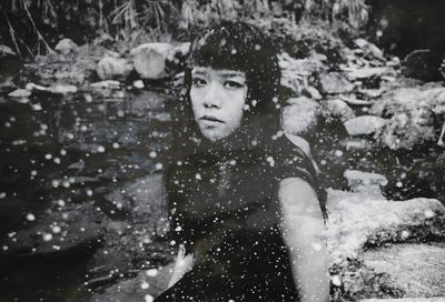 Portrait of young woman standing outdoors during winter