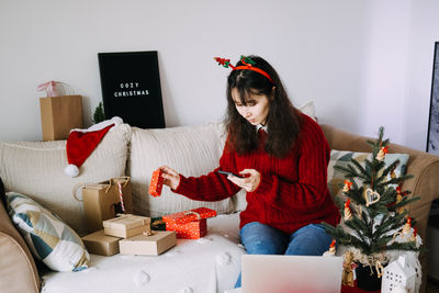 Young woman using laptop at home