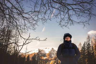 Portrait of young woman standing on snow covered landscape