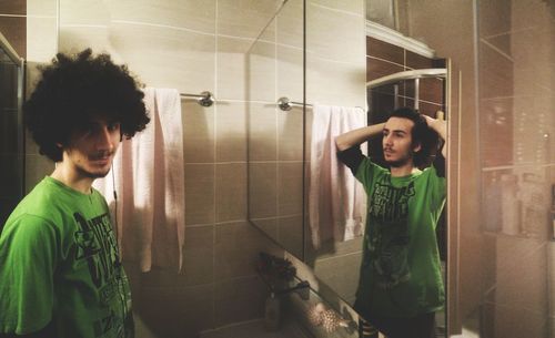 Portrait of young man standing in bathroom