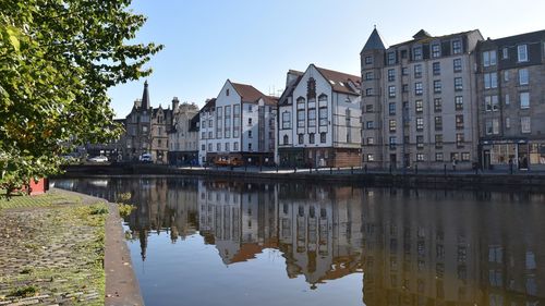 Reflection of buildings on canal in city