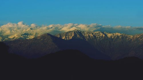 Scenic view of silhouette mountains against sky